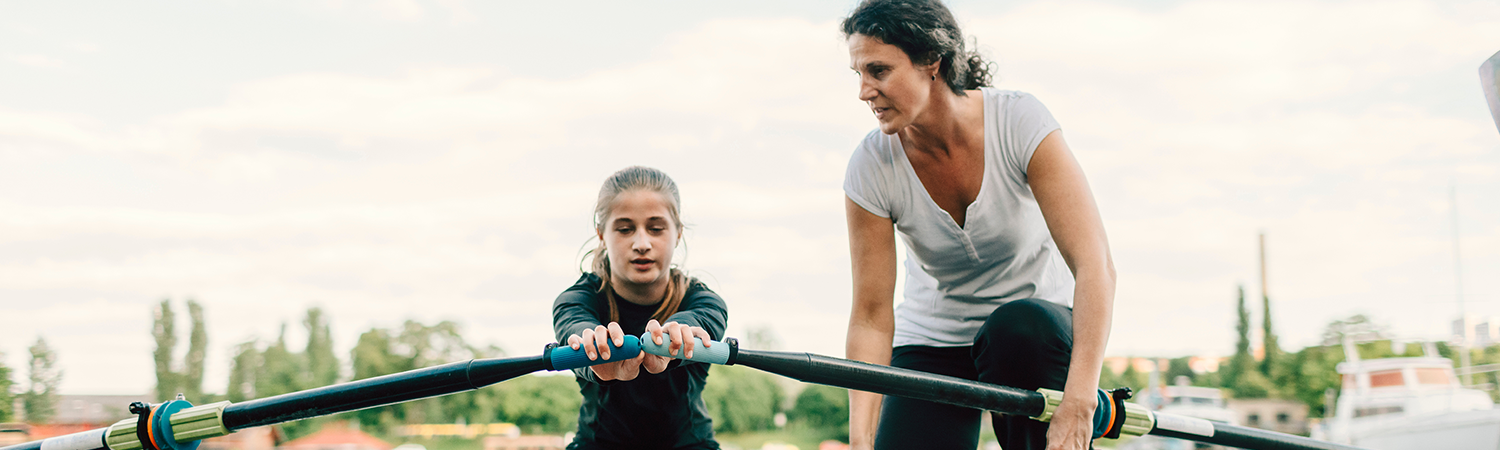 Mother showing her child how to row